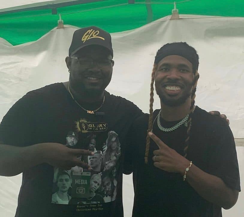Glory in the Beat and an artist smile for a photo in a festival tent.